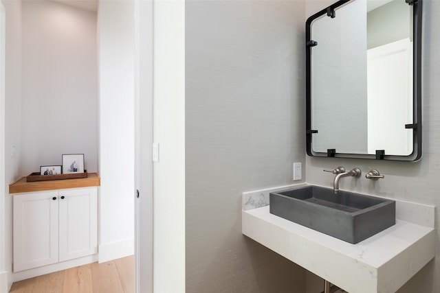 bathroom with wood-type flooring and sink