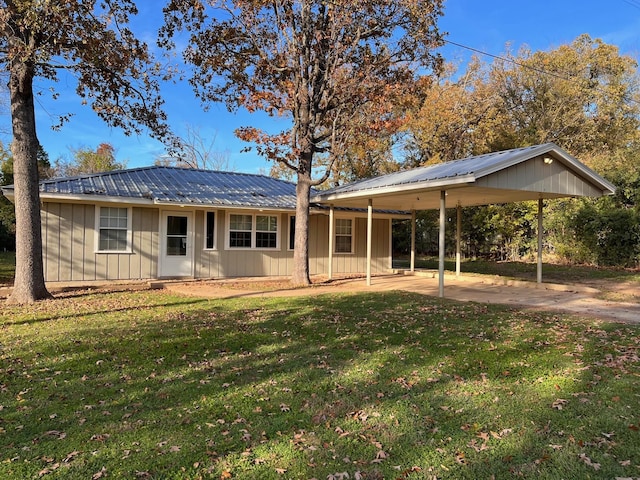 back of house featuring a yard and a carport