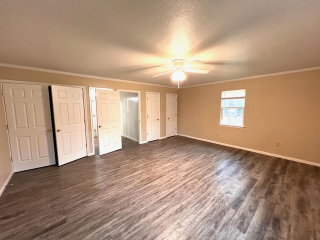 unfurnished bedroom with crown molding, dark wood-type flooring, a textured ceiling, and ceiling fan