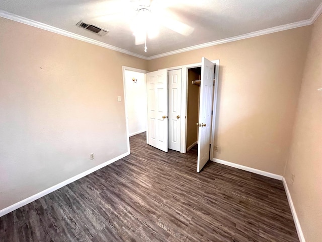 unfurnished bedroom with crown molding, ceiling fan, and dark hardwood / wood-style floors