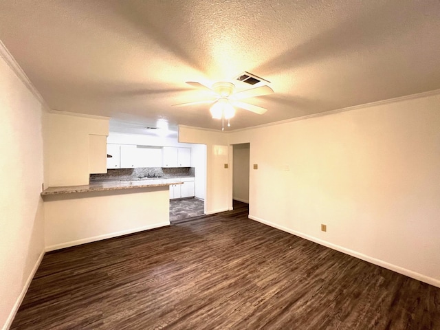 unfurnished living room featuring ornamental molding, dark hardwood / wood-style flooring, and ceiling fan