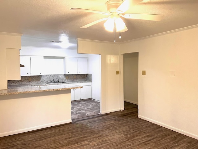 kitchen with sink, crown molding, ceiling fan, white cabinetry, and tasteful backsplash