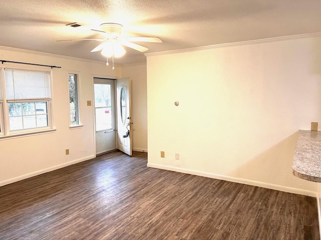 unfurnished room featuring ceiling fan, ornamental molding, dark hardwood / wood-style floors, and a textured ceiling