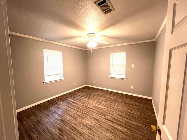 spare room featuring a healthy amount of sunlight, ceiling fan, crown molding, dark wood-type flooring, and a textured ceiling