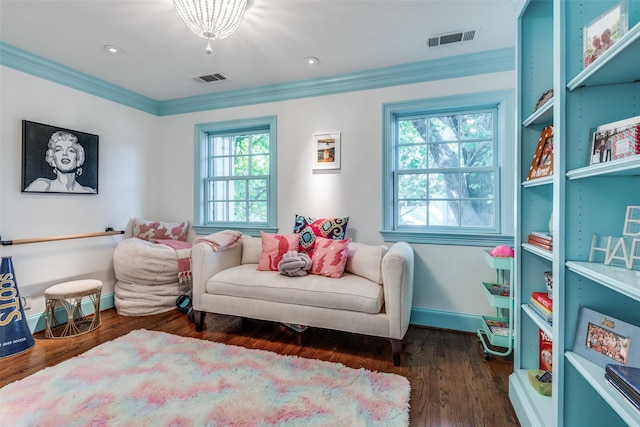 living area with crown molding and dark wood-type flooring