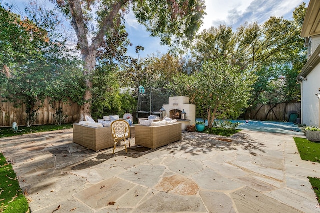 view of patio / terrace featuring an outdoor living space with a fireplace