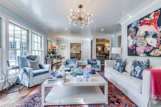 living room with ornamental molding, hardwood / wood-style floors, and a chandelier