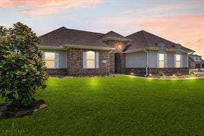 ranch-style home featuring a lawn