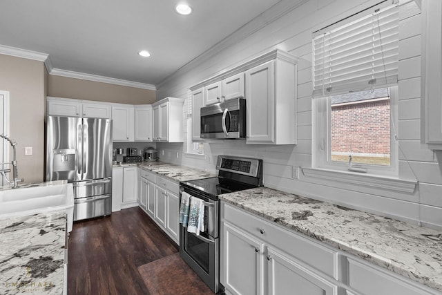 kitchen with sink, crown molding, dark hardwood / wood-style floors, stainless steel appliances, and white cabinets