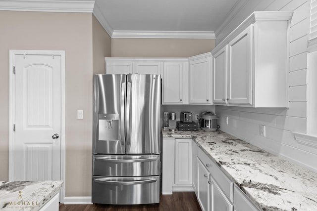 kitchen featuring stainless steel fridge with ice dispenser, crown molding, light stone countertops, and white cabinets