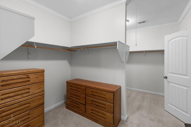 walk in closet featuring light colored carpet