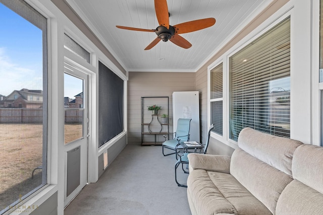 sunroom / solarium with a healthy amount of sunlight and ceiling fan