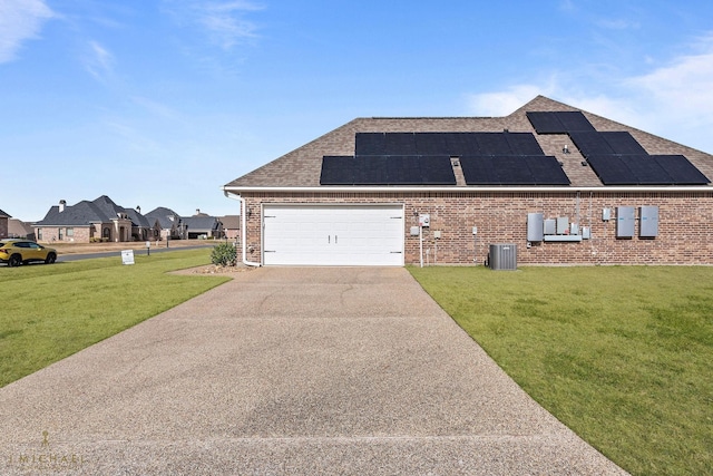 view of front of property featuring central AC unit, a garage, a front yard, and solar panels