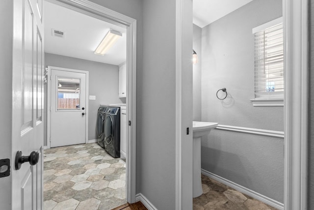 bathroom with independent washer and dryer