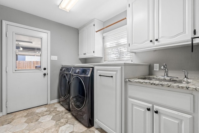 washroom featuring cabinets, sink, and washer and dryer