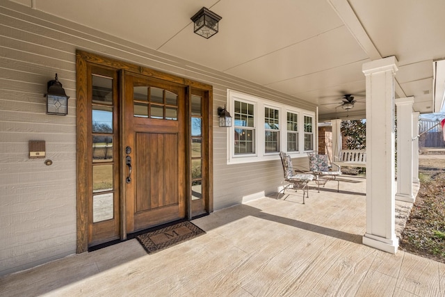 entrance to property featuring ceiling fan and covered porch