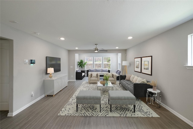 living room with ceiling fan and hardwood / wood-style floors