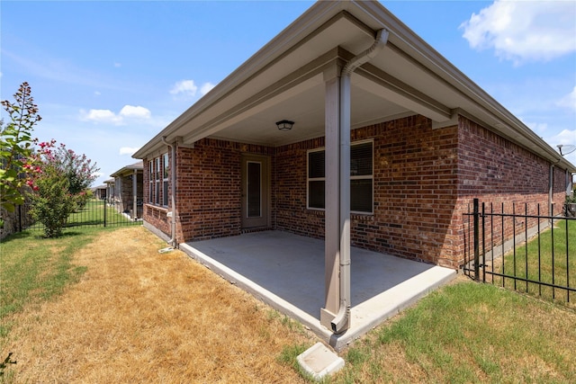 back of property with a yard and a patio area