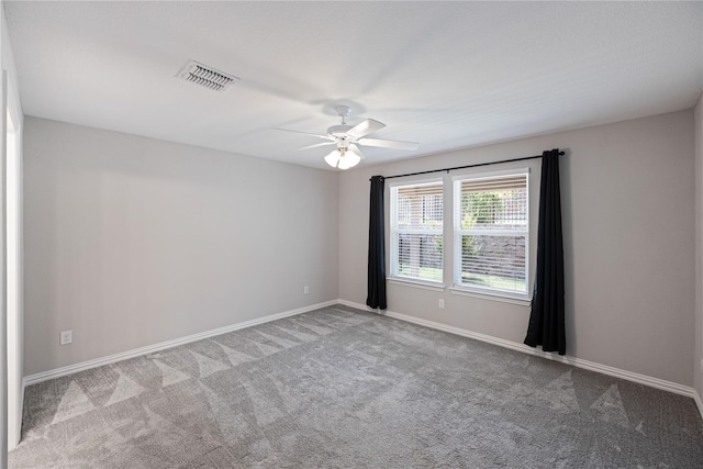 carpeted spare room with ceiling fan