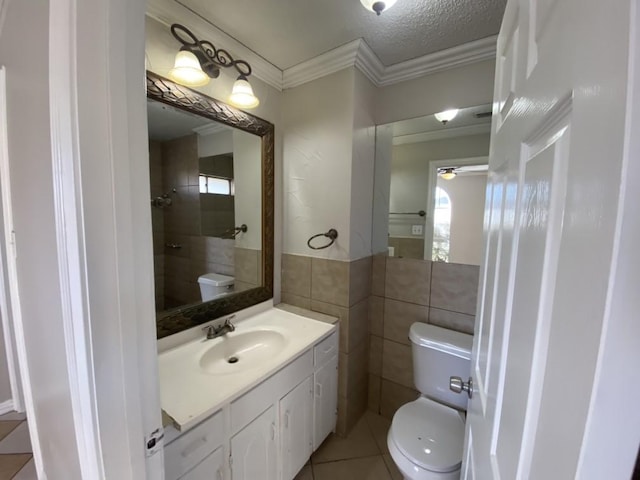 bathroom featuring crown molding, tile walls, a textured ceiling, vanity, and tile patterned flooring