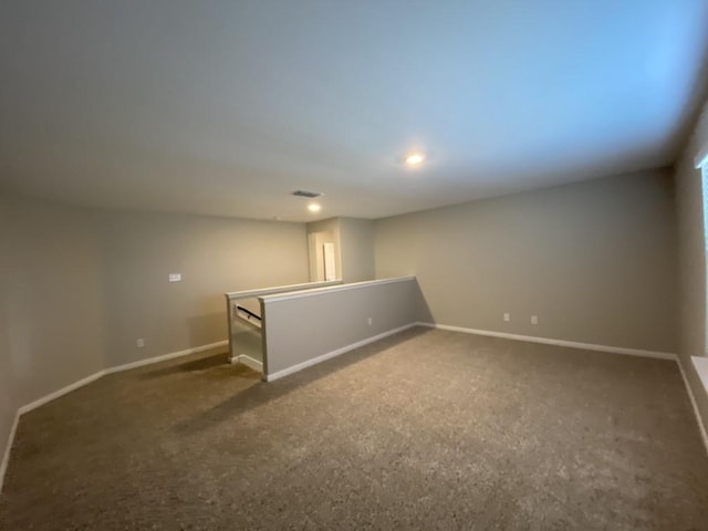 basement featuring dark colored carpet