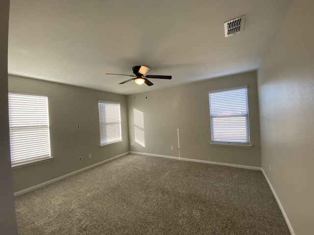 unfurnished room with ceiling fan and carpet flooring