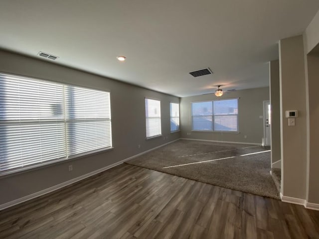 empty room with dark wood-type flooring and ceiling fan