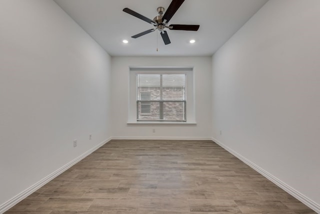 unfurnished room with ceiling fan and light hardwood / wood-style flooring