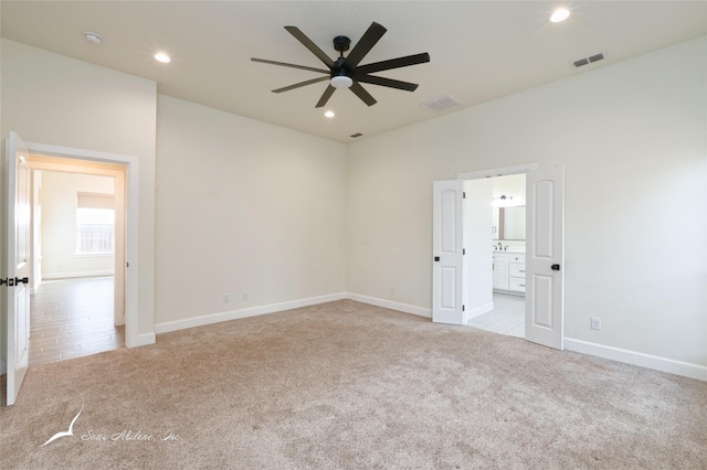 spare room with light carpet and ceiling fan