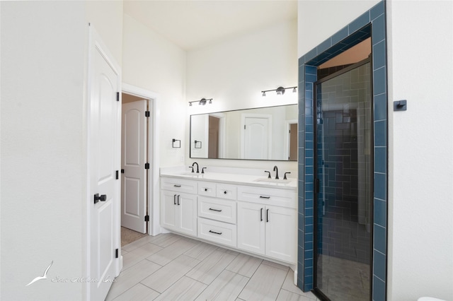 bathroom featuring vanity and a shower with door