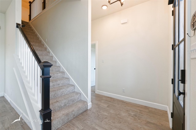 stairs featuring hardwood / wood-style floors