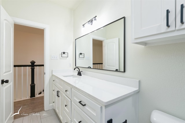 bathroom with vanity, wood-type flooring, and toilet