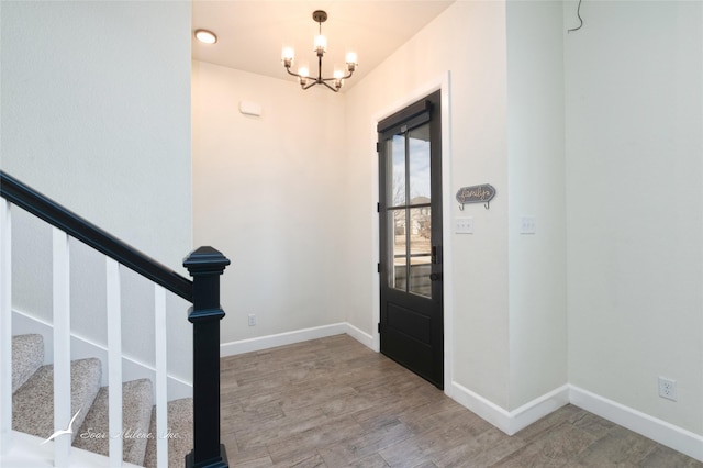 entrance foyer with hardwood / wood-style flooring and a chandelier