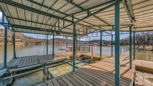 view of dock with a water and mountain view