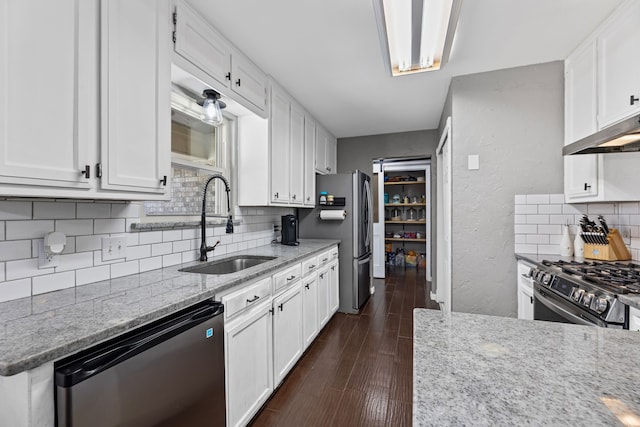 kitchen featuring sink, white cabinetry, dark hardwood / wood-style flooring, stainless steel appliances, and light stone countertops