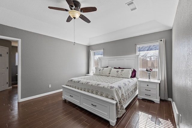 bedroom with a tray ceiling and ceiling fan