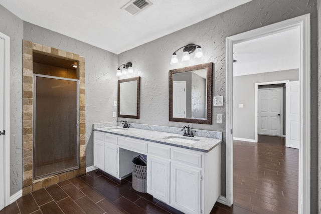 bathroom with vanity and an enclosed shower