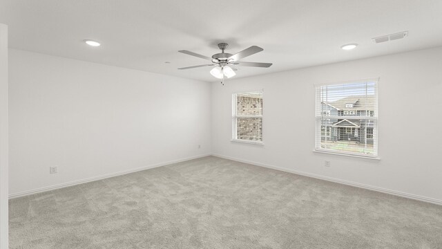 spare room featuring visible vents, baseboards, recessed lighting, a ceiling fan, and carpet