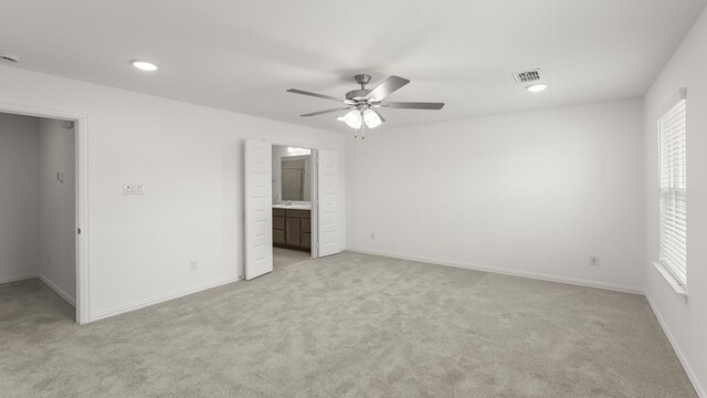 unfurnished bedroom with visible vents, baseboards, and light colored carpet
