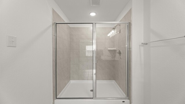 full bathroom with visible vents and a stall shower