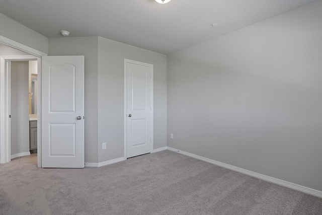 unfurnished bedroom featuring light carpet