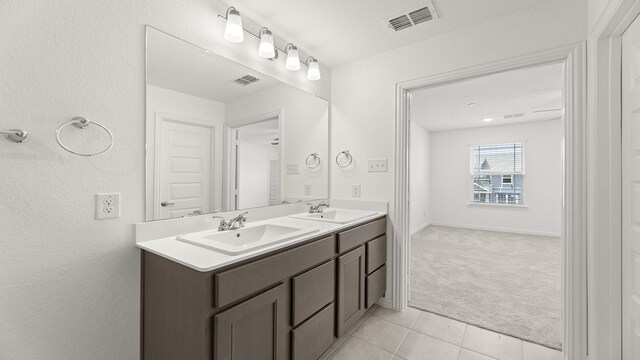full bath with visible vents, a sink, and tile patterned flooring