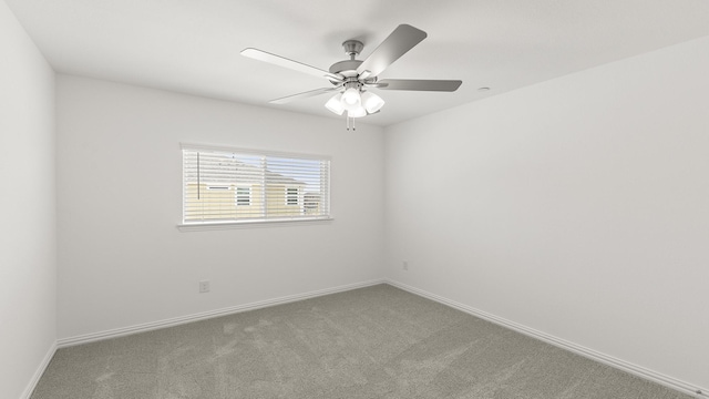 unfurnished room featuring baseboards, ceiling fan, and carpet