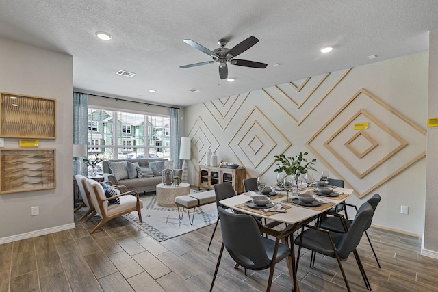 dining space with ceiling fan and a textured ceiling