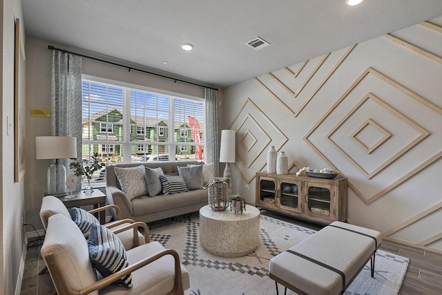 living room with hardwood / wood-style floors and a textured ceiling