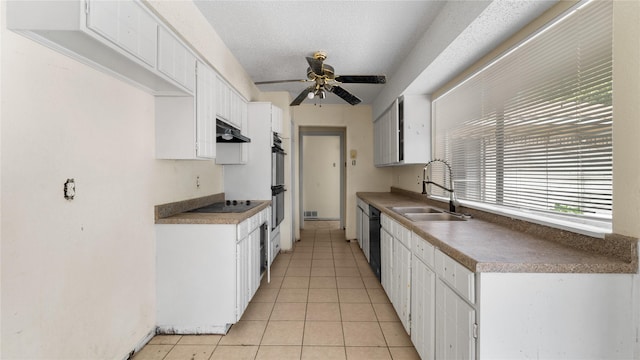 kitchen with sink, white cabinetry, a textured ceiling, light tile patterned floors, and black appliances