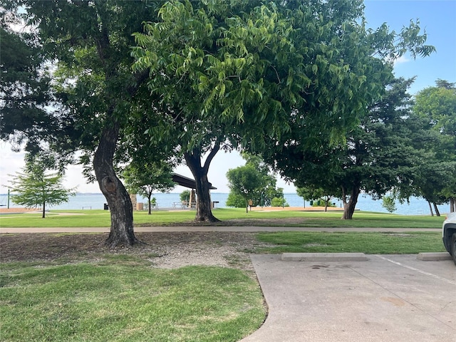 view of community with a water view and a lawn