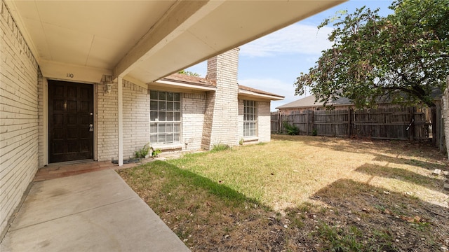 entrance to property featuring a yard