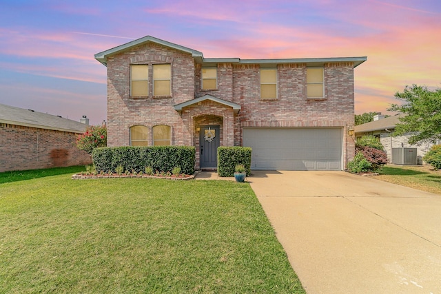 traditional home featuring brick siding, concrete driveway, a garage, cooling unit, and a front lawn