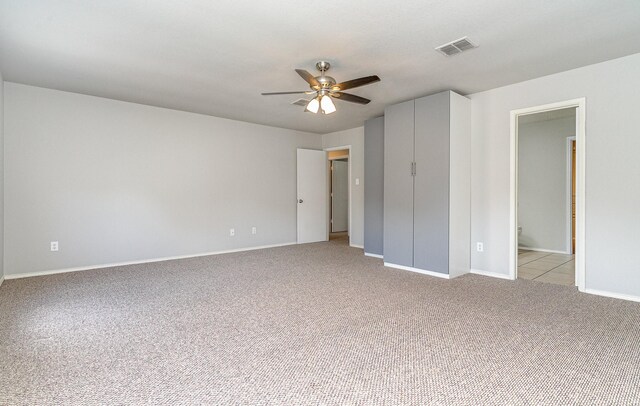 carpeted bedroom featuring connected bathroom and ceiling fan